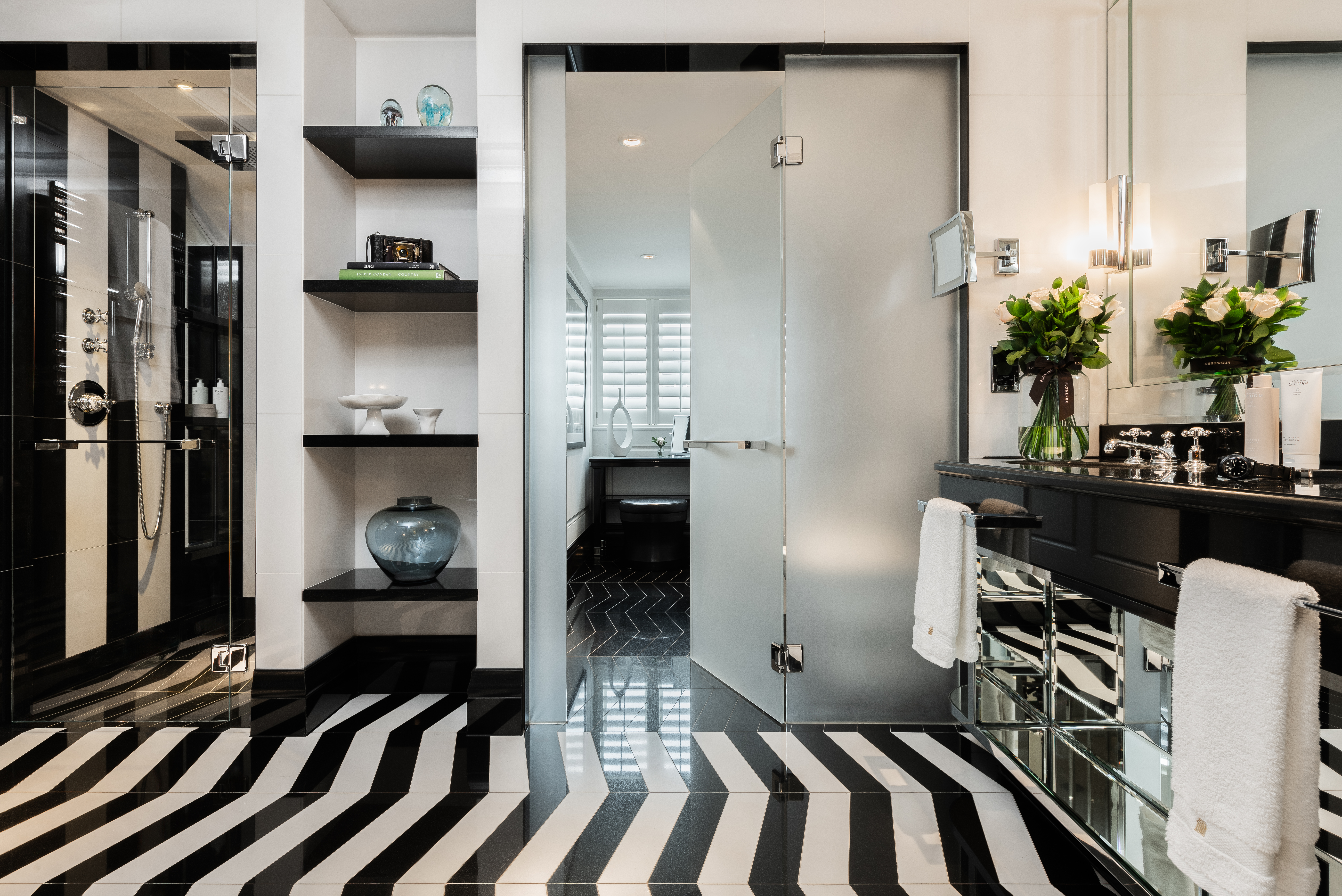 Penthouse suite bathroom at Corinthia London luxury hotel near the River Thames, featuring walk-in shower, dual sink and premium amenities"