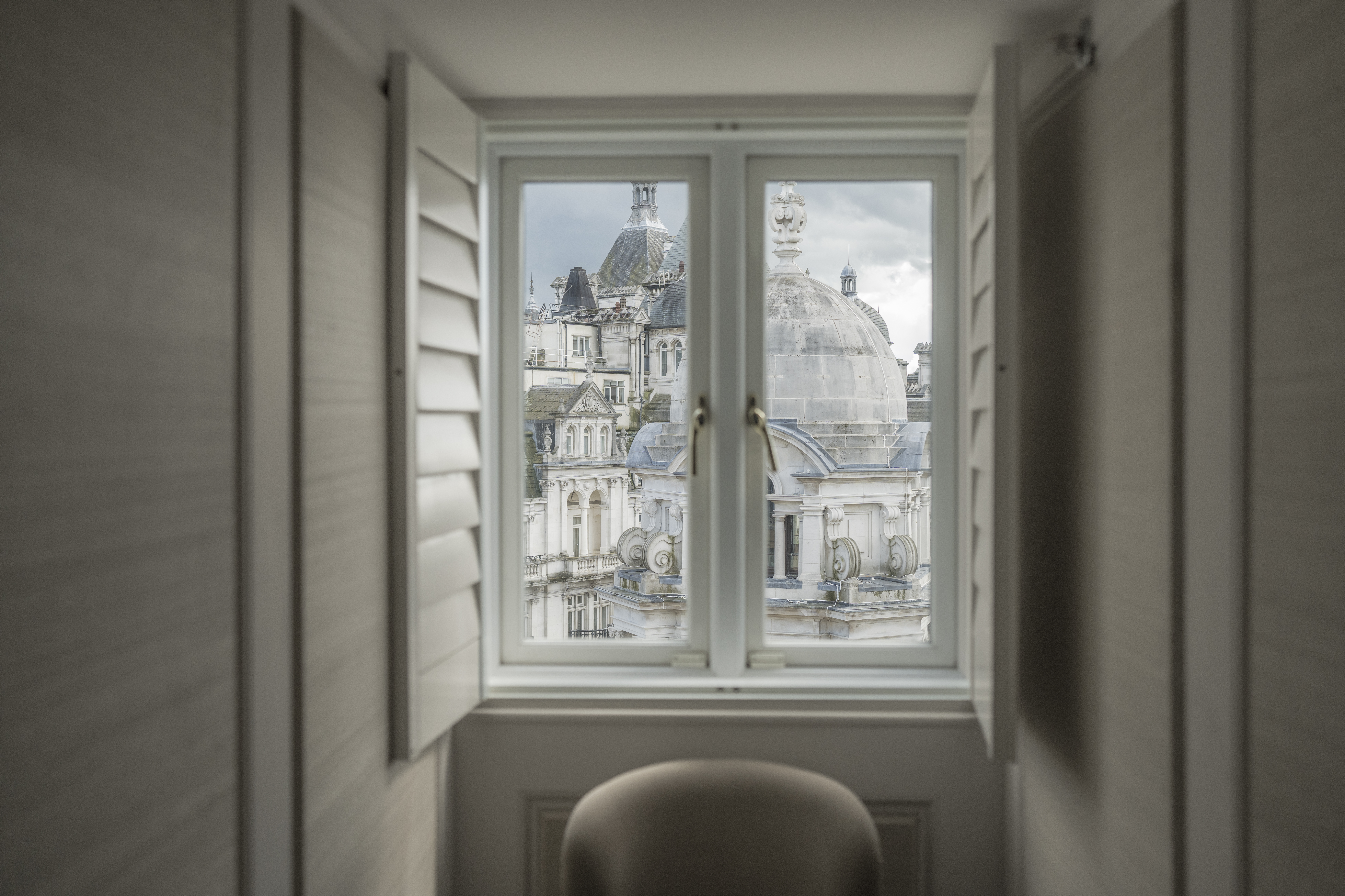 Explorer Penthouse window at Corinthia London luxury hotel peering into London cityscape