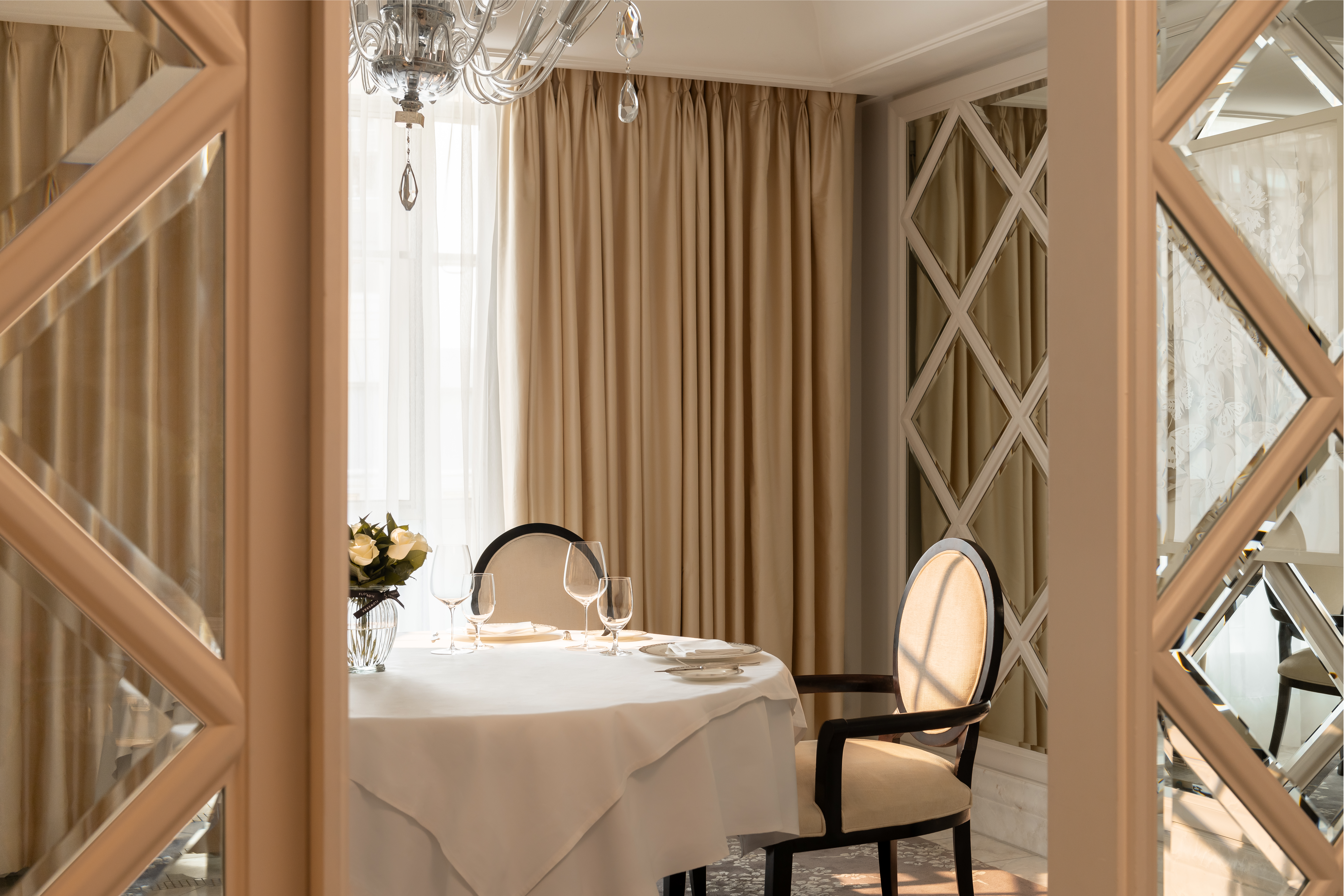 Sun shining into dining area of penthouse suite at Corinthia London luxury hotel near Trafalgar Square