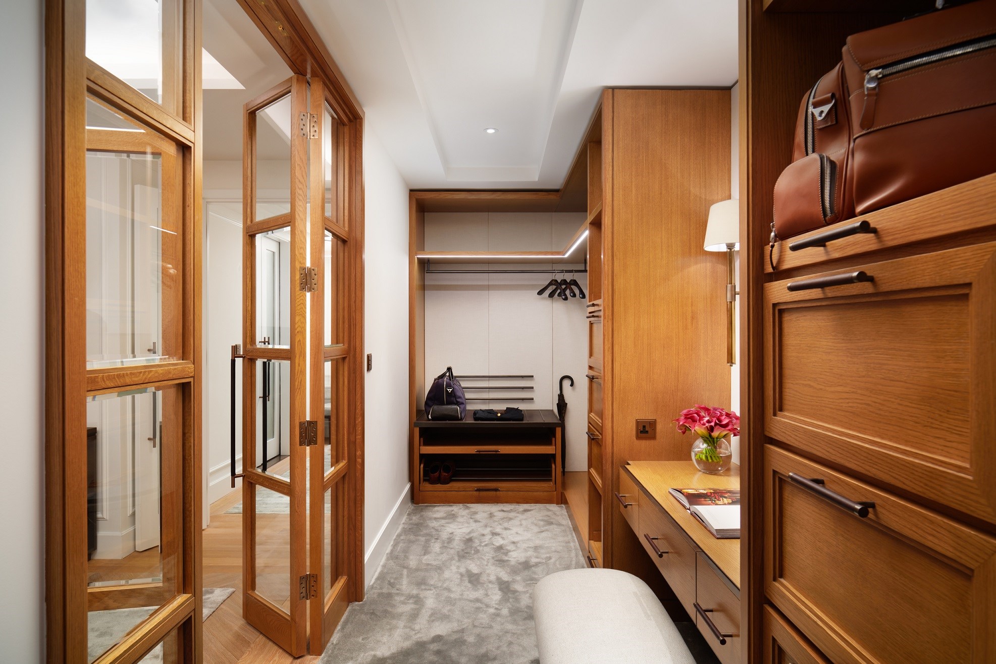 Wooden walk-in wardrobe with grey carpet