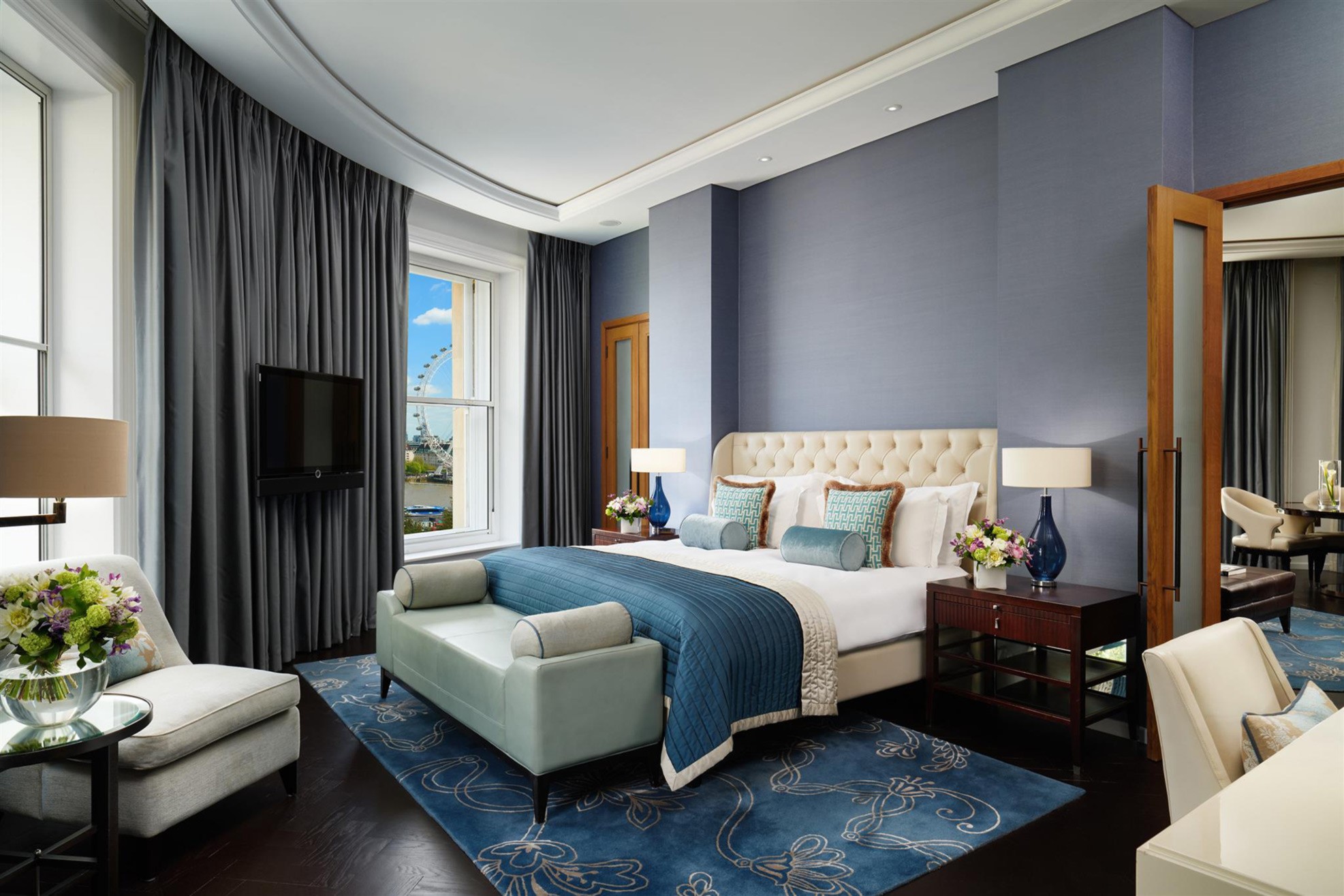 The River Suite at Corinthia London featuring a spacious living area and panoramic views of the River Thames.
