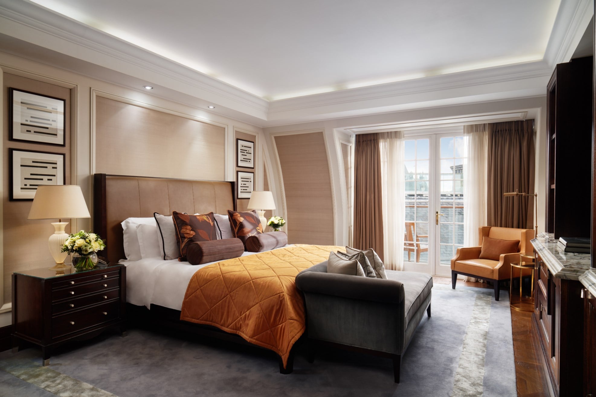 Writer’s Penthouse bedroom at Corinthia London featuring a large window overlooking the terrace, a Hästens king-size mattress and luxurious amenities throughout.
