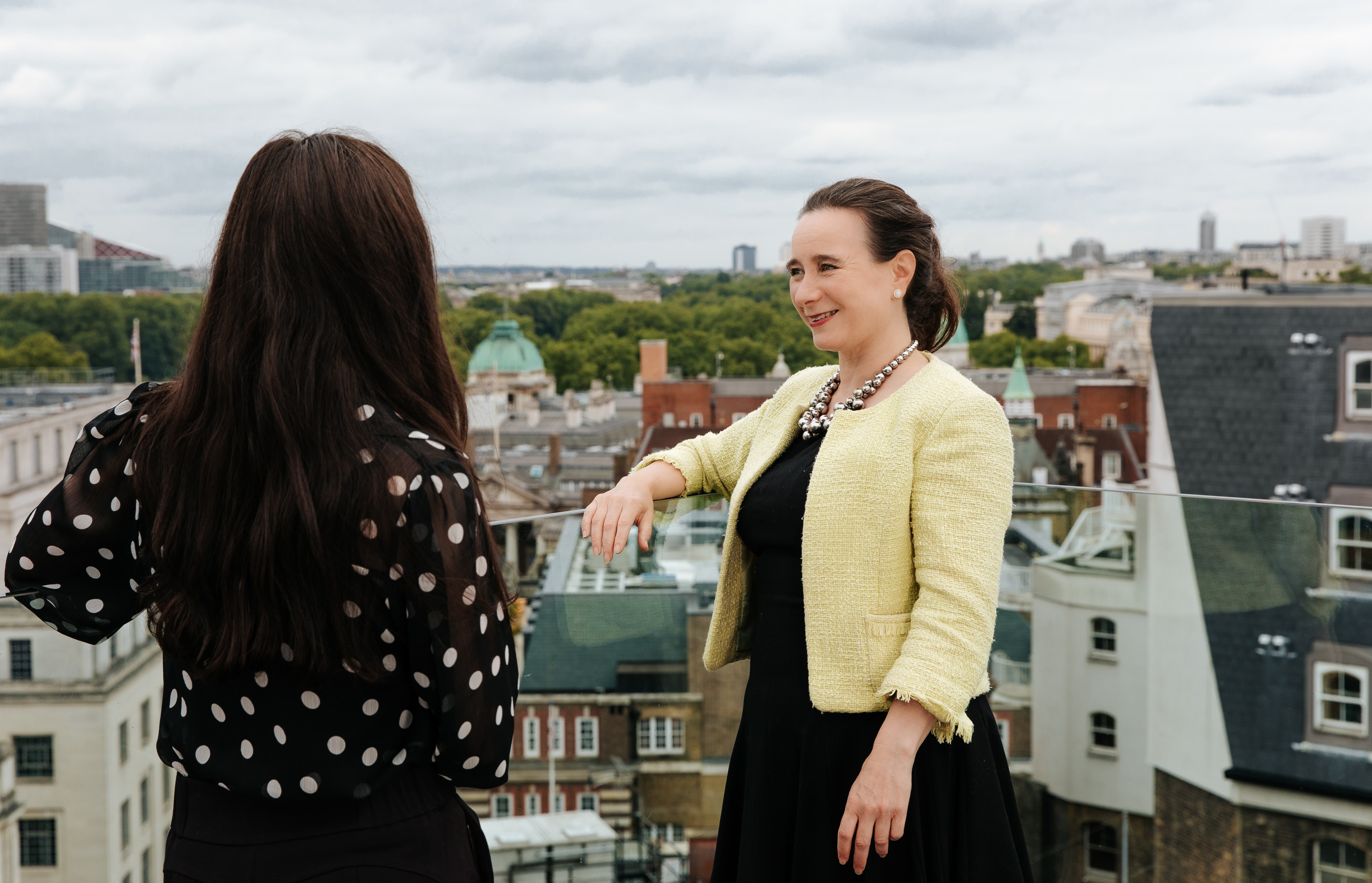 Two women on a balcony with London views