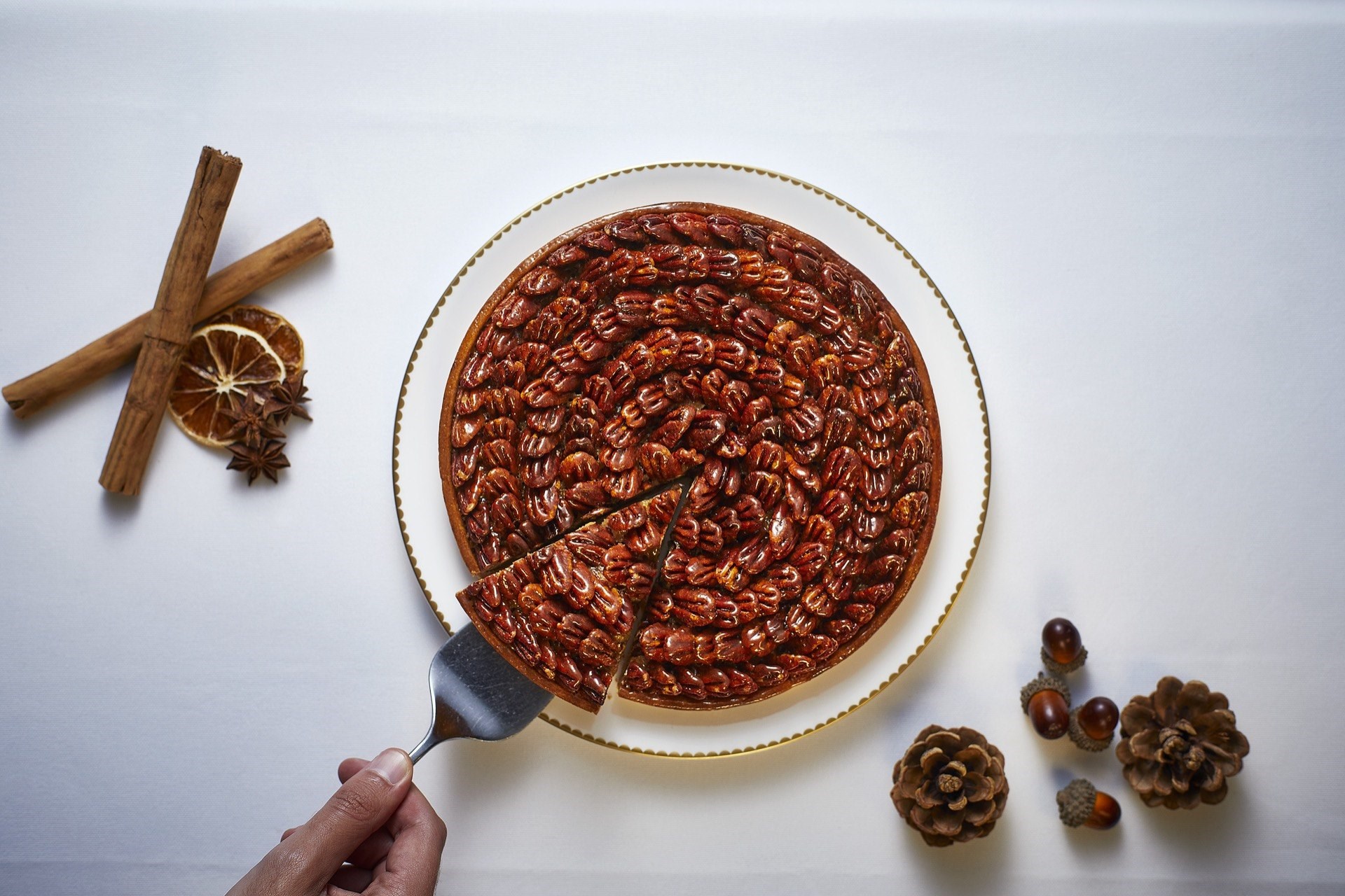 Taking a slice from a pecan pie