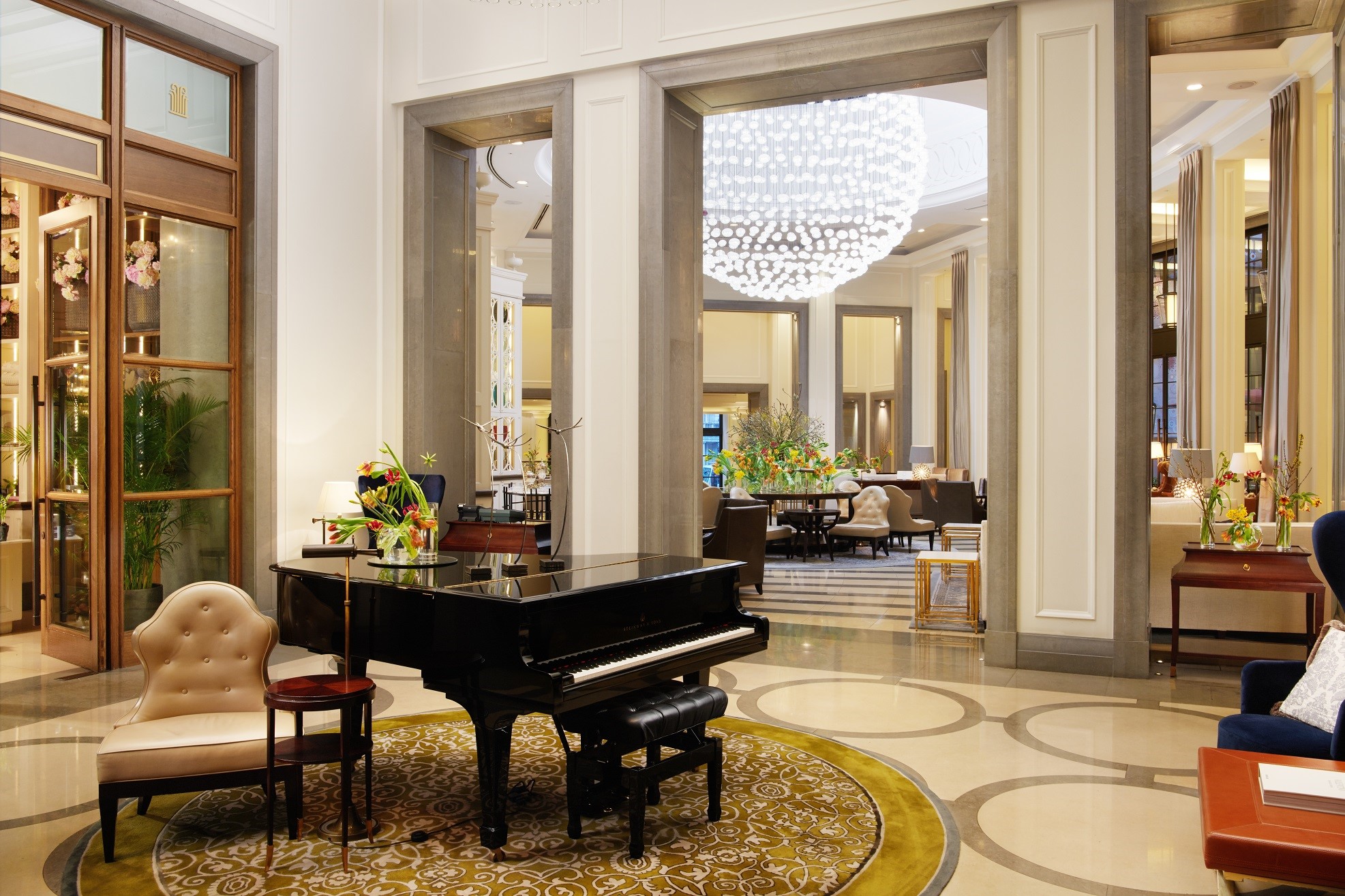 Piano and chandelier in hotel lobby