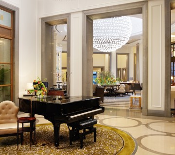 Piano and chandelier in hotel lobby