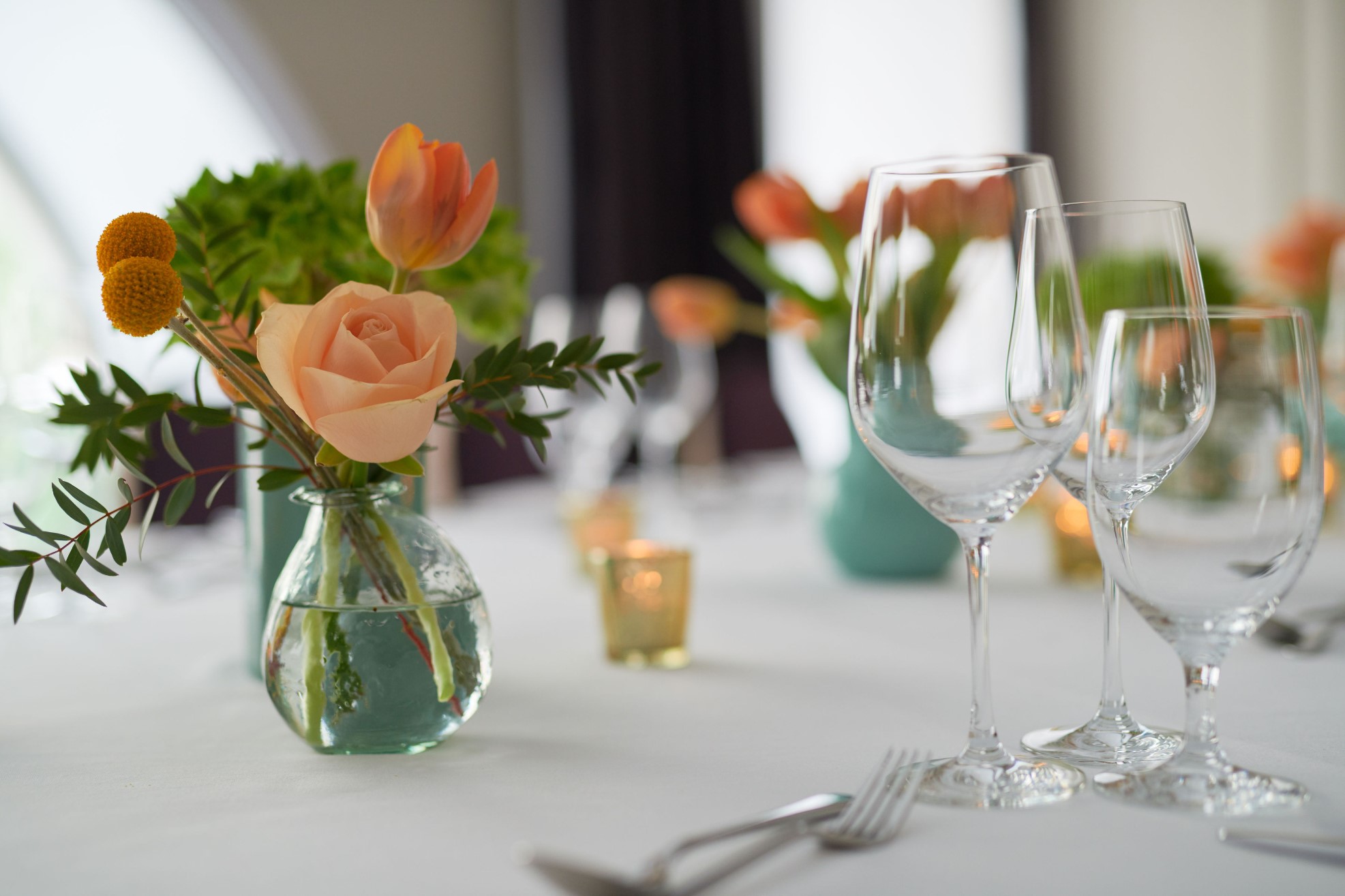 Flowers and glasses on a dinner table
