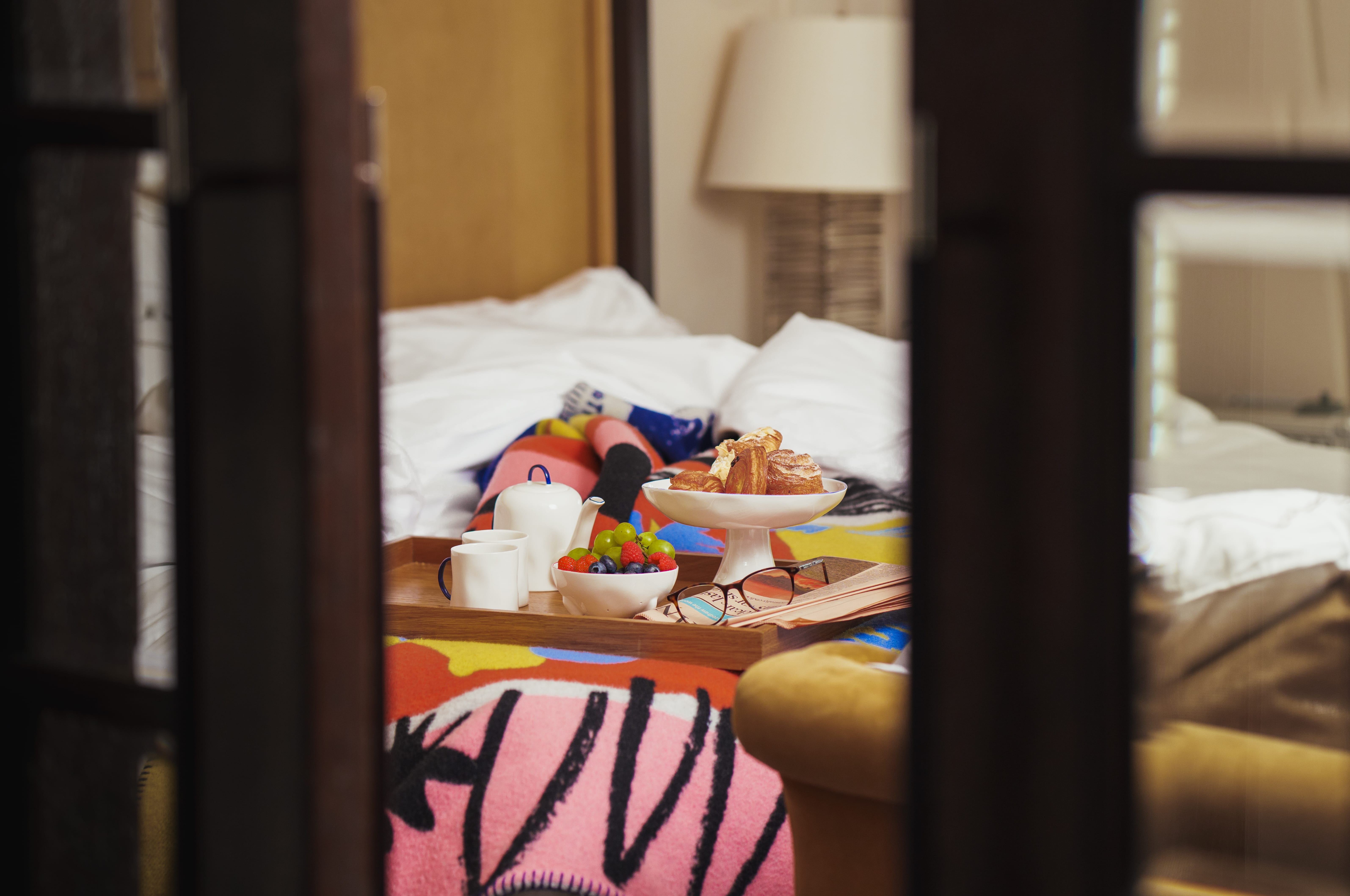 Breakfast from Corinthia London’s in-room dining menu with fresh pastries, seasonal fruit and a handcrafted mug made by Feldspar, elegantly presented on a tray