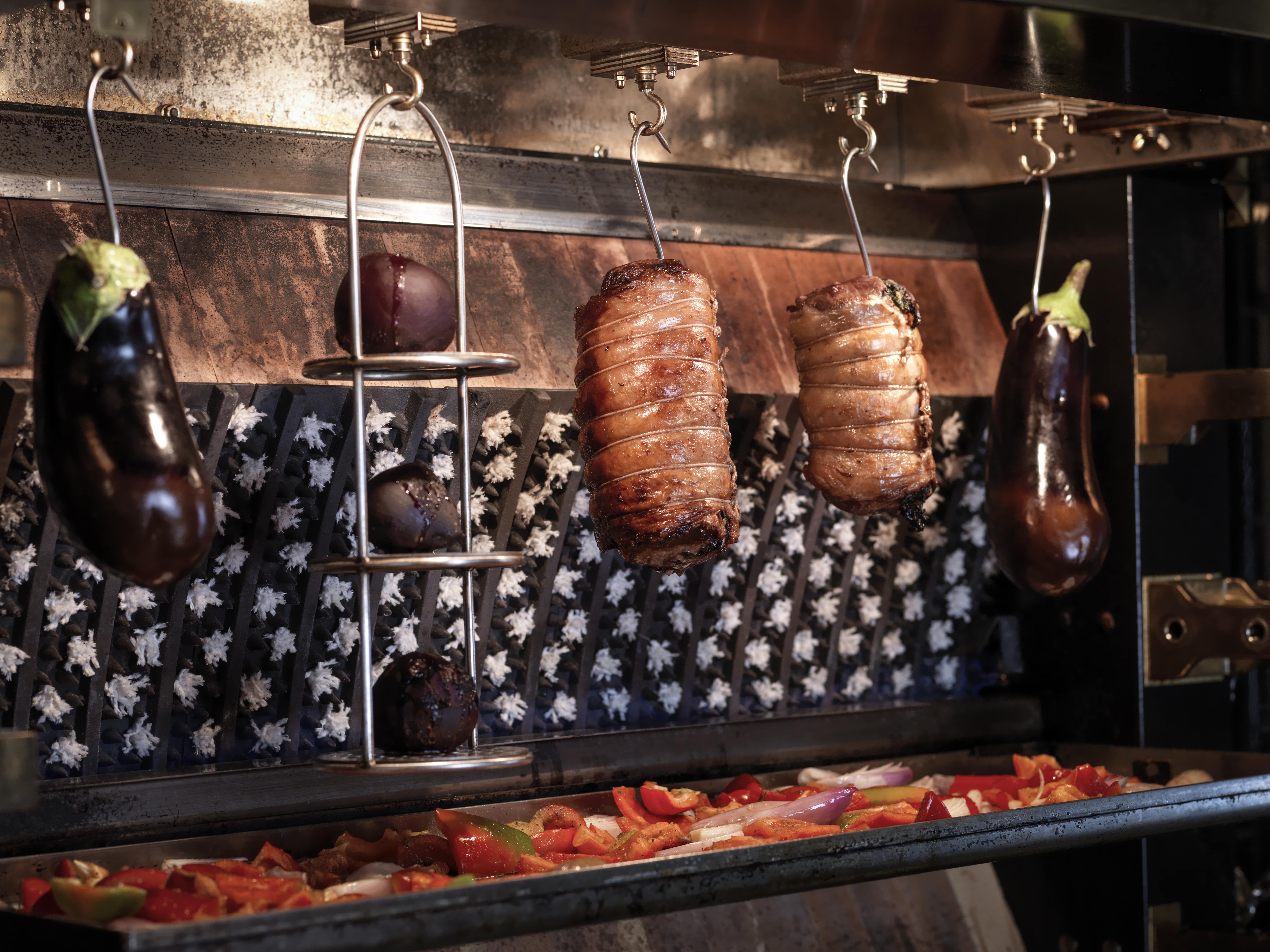 Traditional rotisserie at Kerridge’s Bar & Grill, showcasing slow-roasted meats and classic cooking techniques