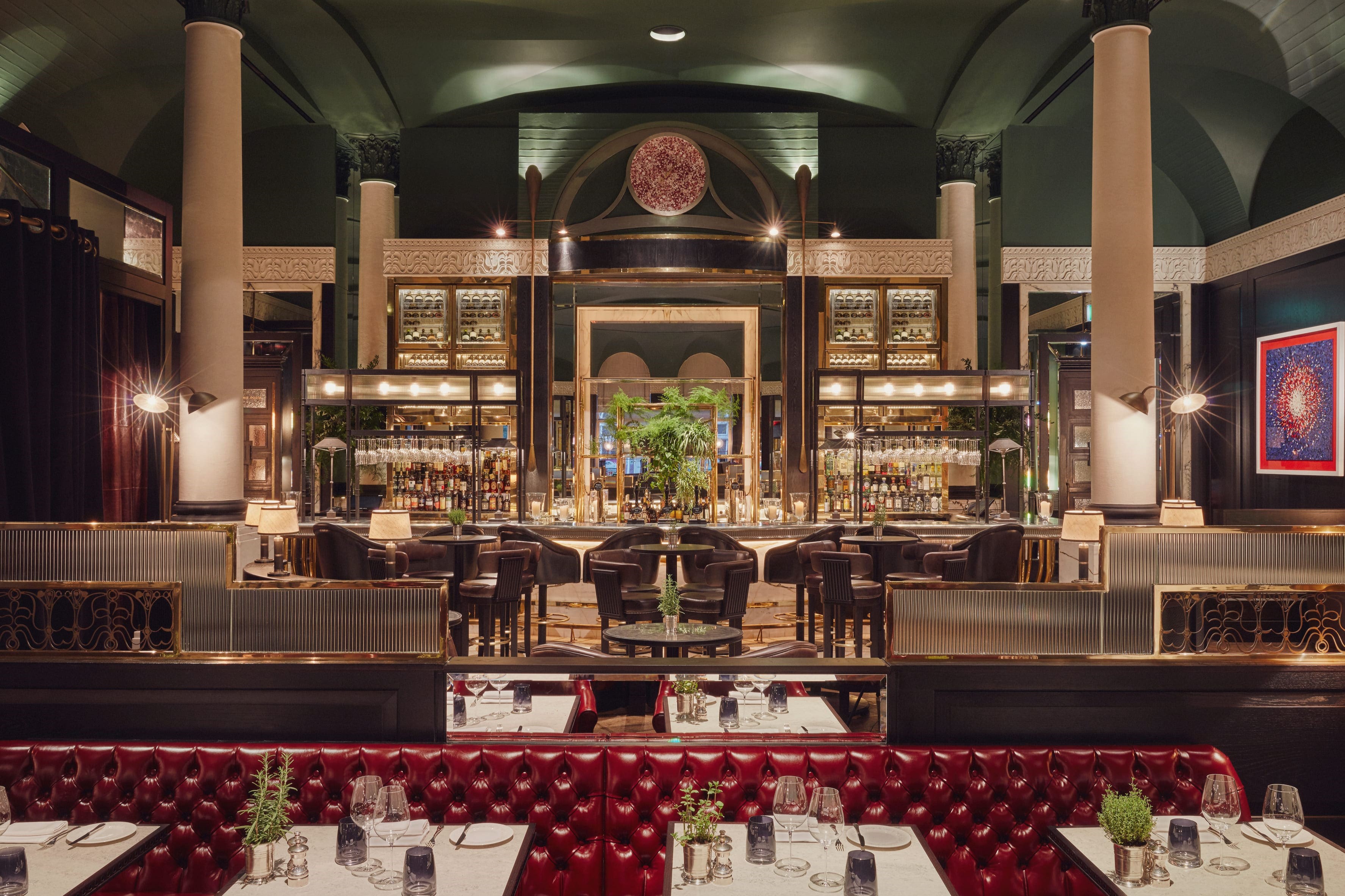 Stylish cocktail bar area featuring vibrant red seating in Kerridge’s Bar & Grill, creating a warm and inviting atmosphere