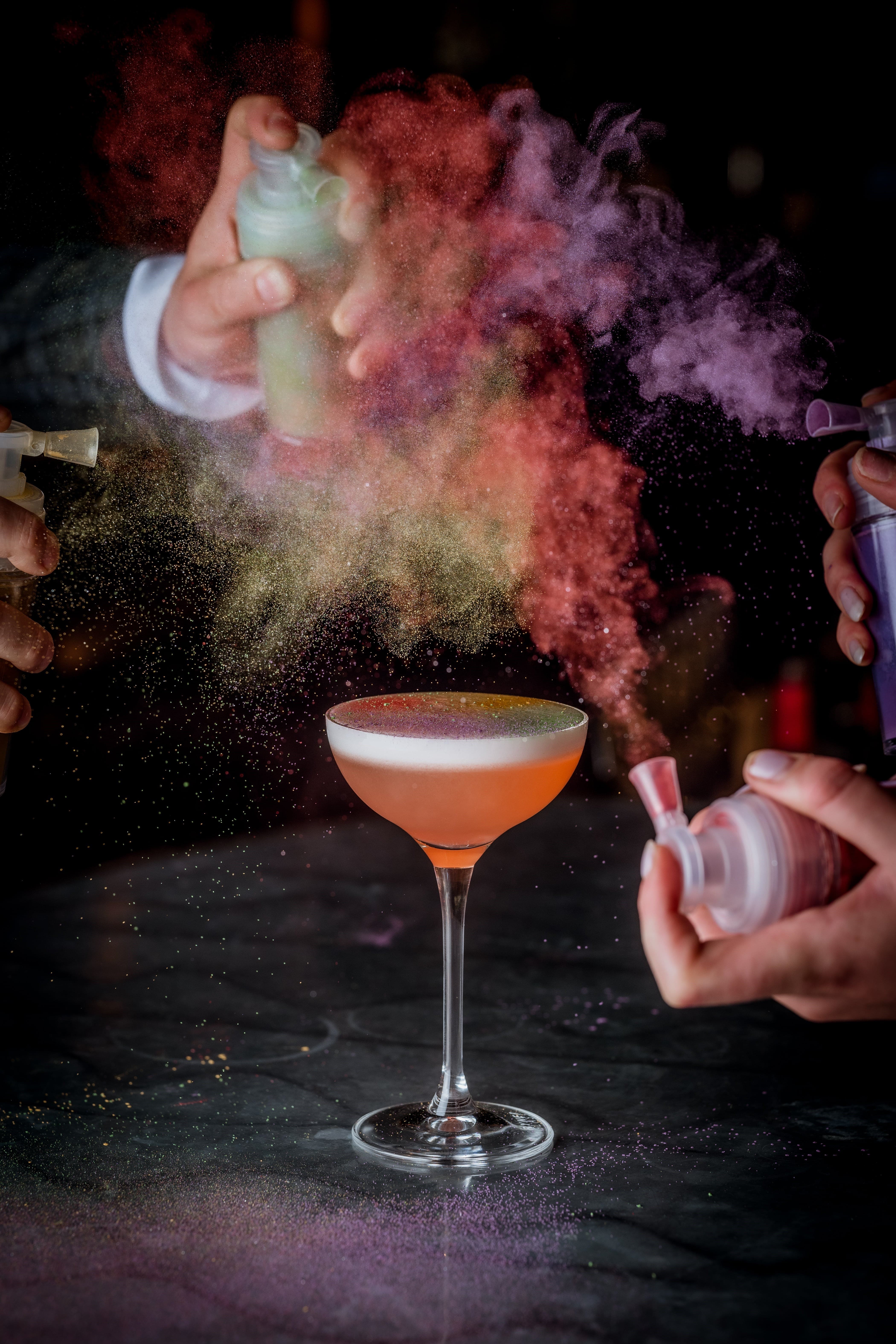 Colourful powders above the Painter's Palette cocktail