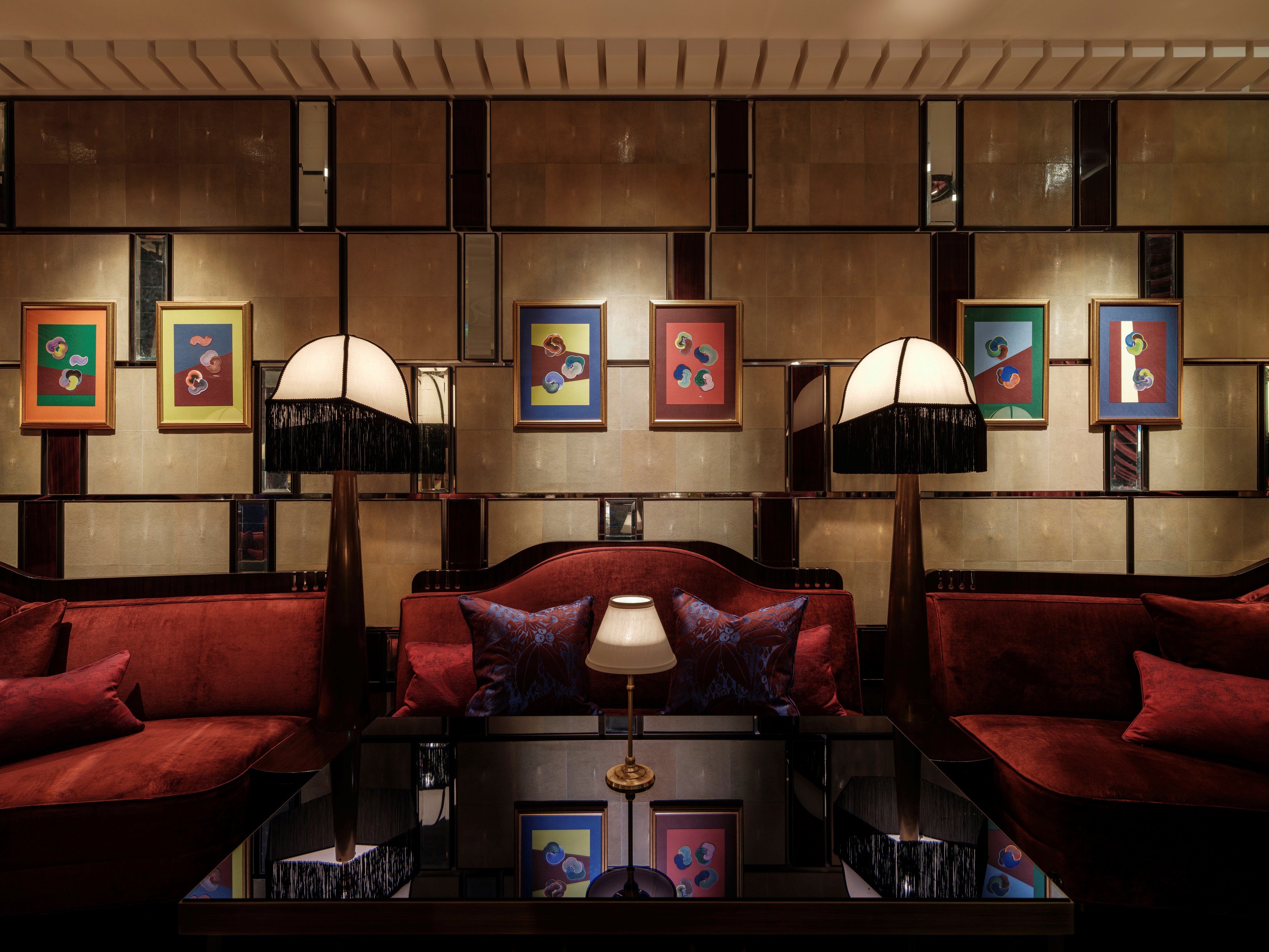 Red velvet seating and artwork in Velvet bar