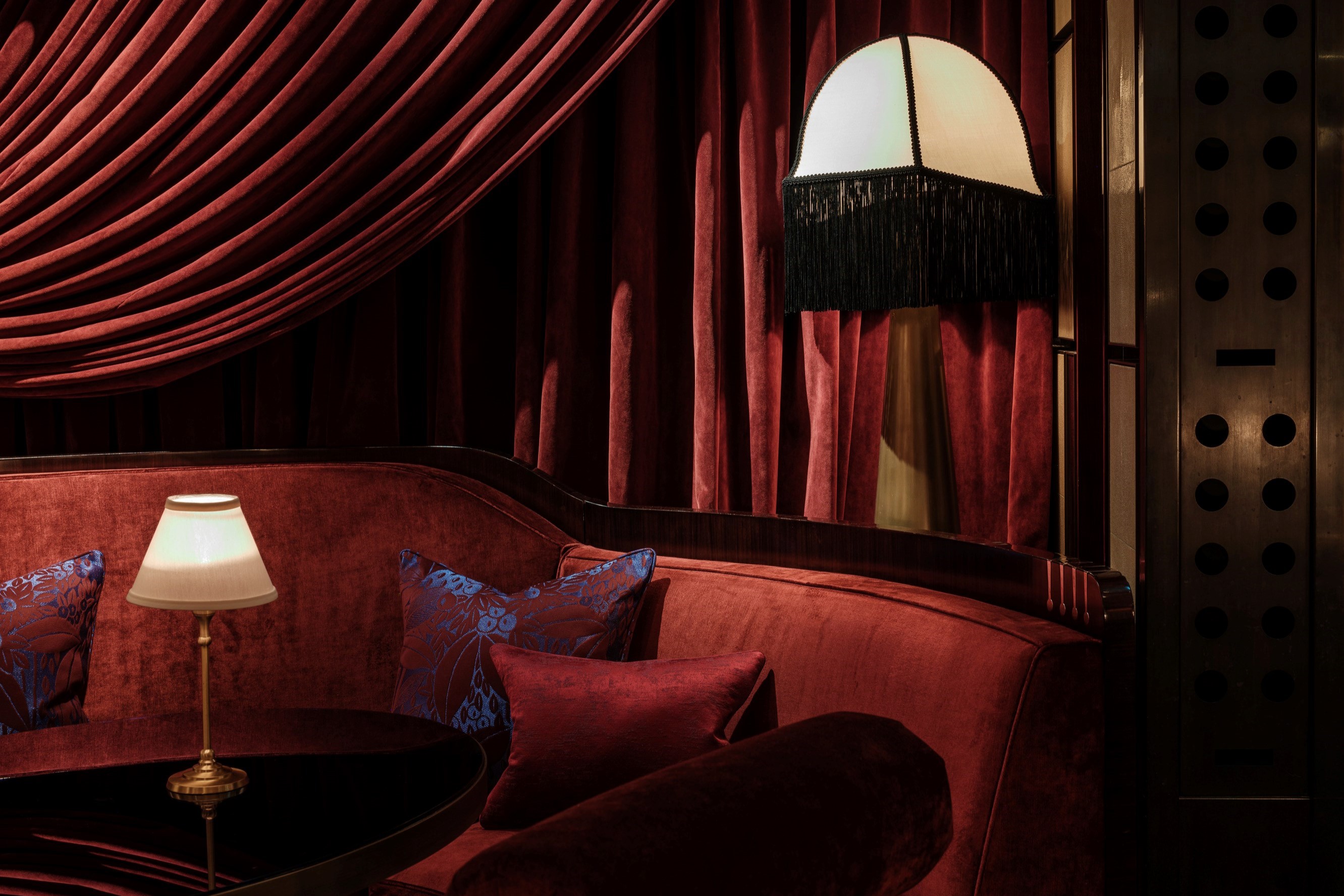 Luxurious red velvet seating at Velvet Bar, creating an elegant and inviting atmosphere