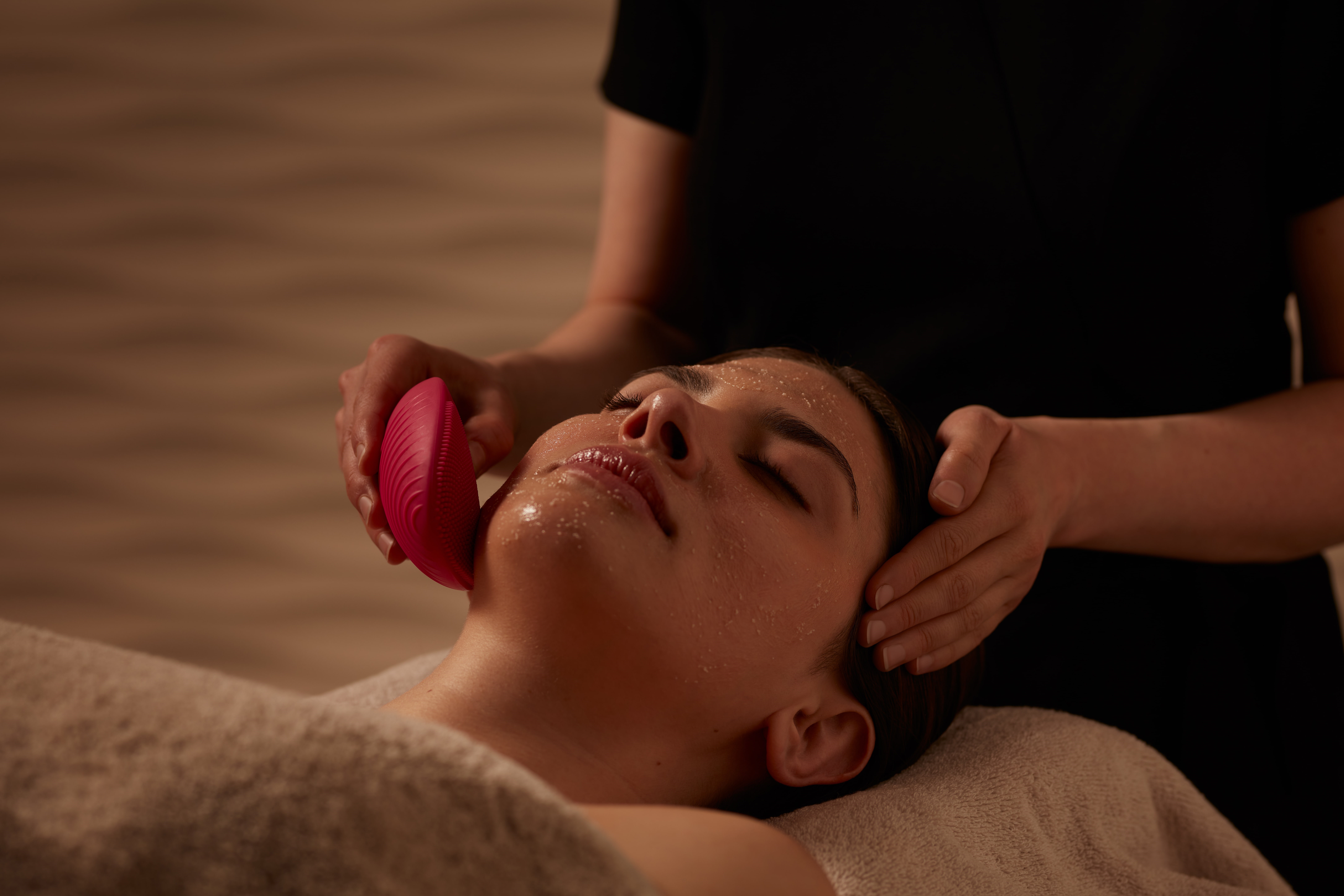 Guest enjoying professional exfoliating facial therapy at ESPA Life at Corinthia spa near Trafalgar Square, London