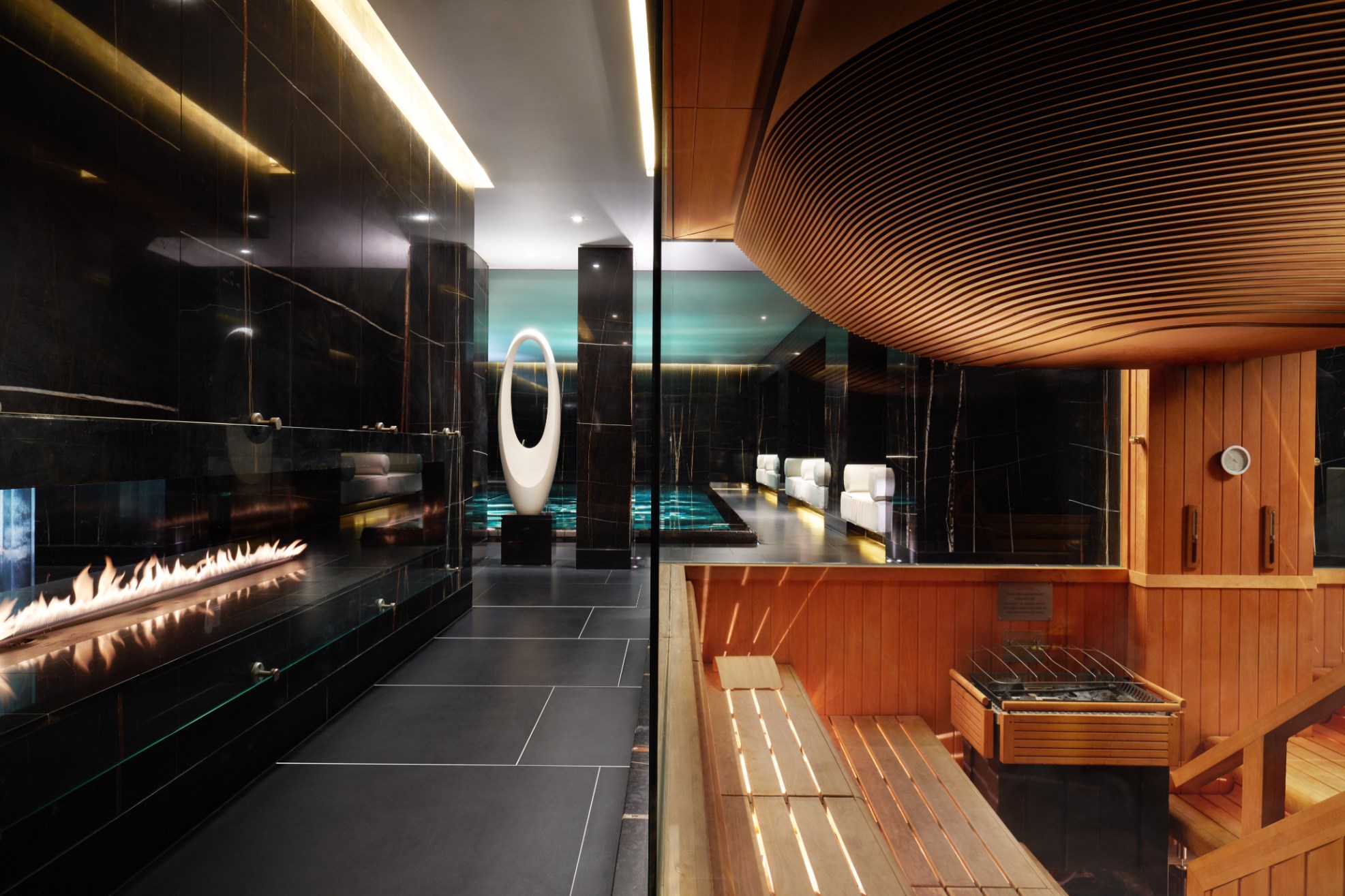 Relaxing spa area featuring swimming pool, sauna and fireplace at ESPA Life at Corinthia luxury hotel spa in London